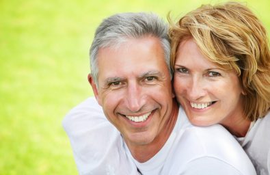 Close-up portrait of a happy mature couple smiling and embracing.