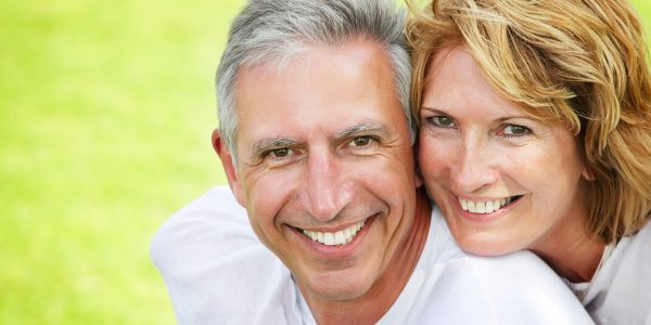 Close-up portrait of a happy mature couple smiling and embracing.